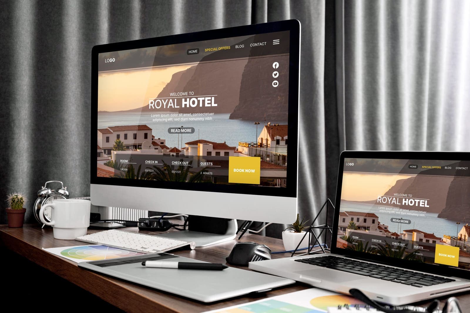 A professional workspace showing responsive website work on multiple screens