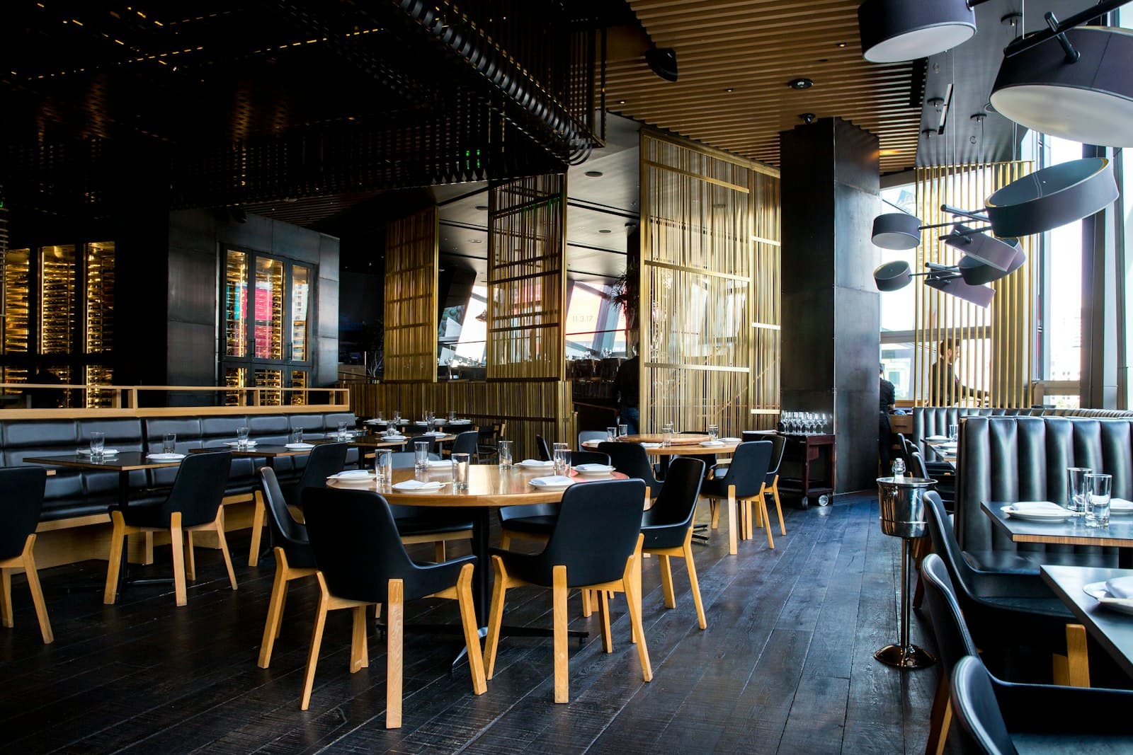 Warmly lit restaurant interior with set tables, used for the restaurant website service section